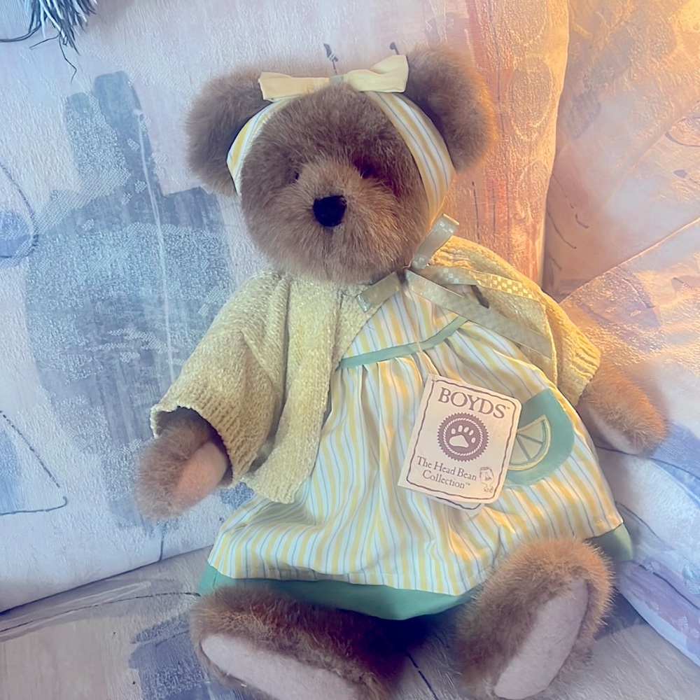 This adorable Boyd’s Bear is dressed I. Yellow with a pretty head band.